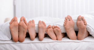 Family feet in bed