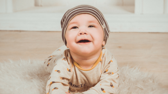 Baby tummy time smiling