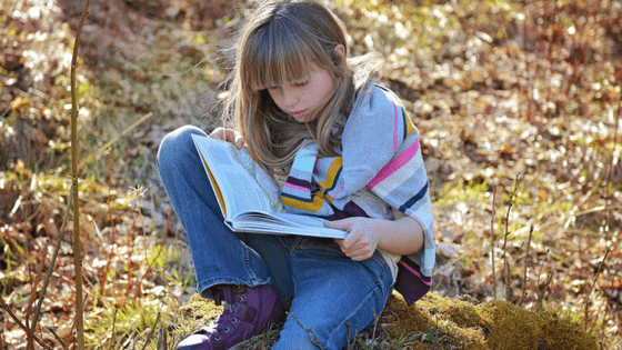 Girl reading outdoors