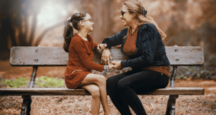 Mother and daughter talking on bench