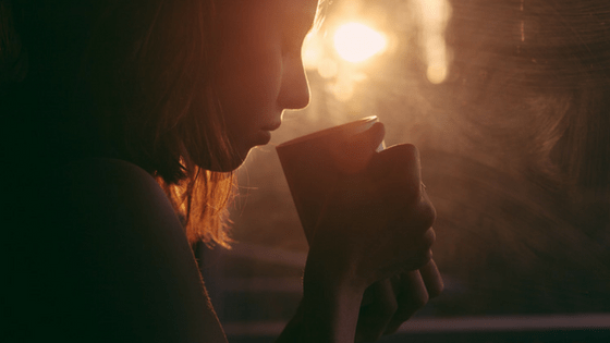 Woman drinking coffee early morning