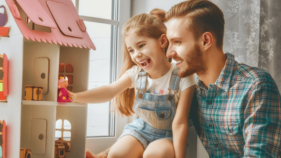 Happy Girl Playing With Doll house