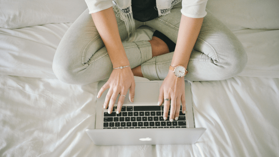 Woman writing on bed