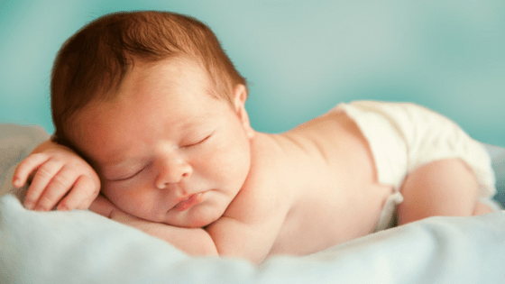 Sleeping newborn baby wearing diaper