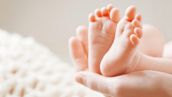 Holding baby feet in hands