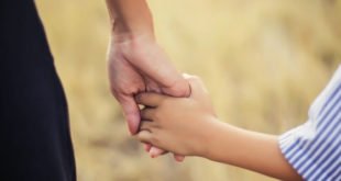 Mother holding sons hand safety