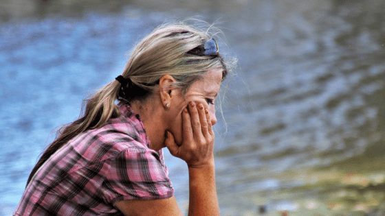 Sad woman by lake