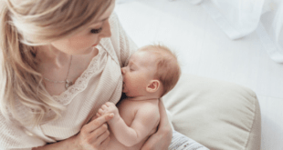 Pretty New mom Breastfeeding Newborn Baby