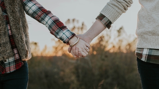 Close couple holding hands