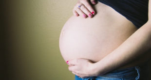 heavily pregnant woman wearing jeans