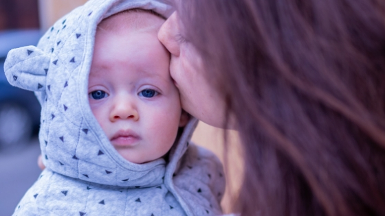 New mom kissing baby