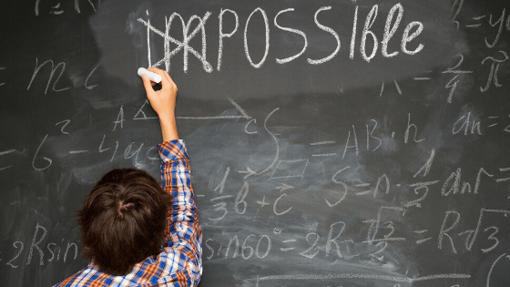 Boy doing math chalkboard