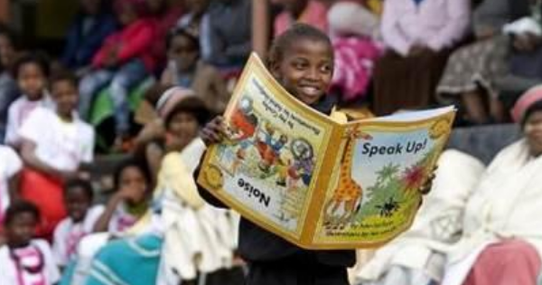 Child holding big book