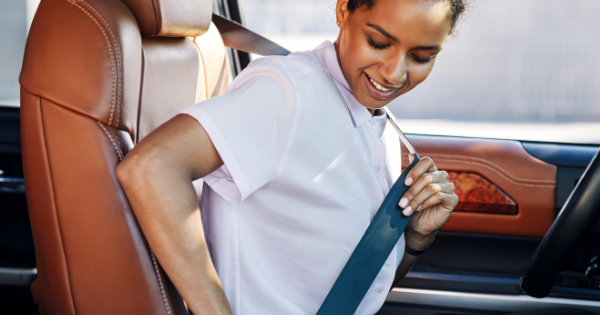 Woman putting seatbelt on