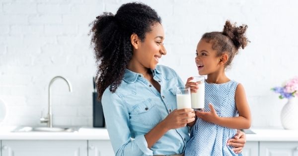 Mother daughter drinking milk