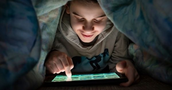 Child Online Hiding Under Blanket