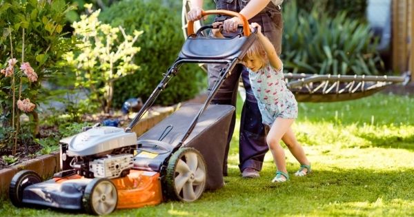 Girl pushing lawnmower