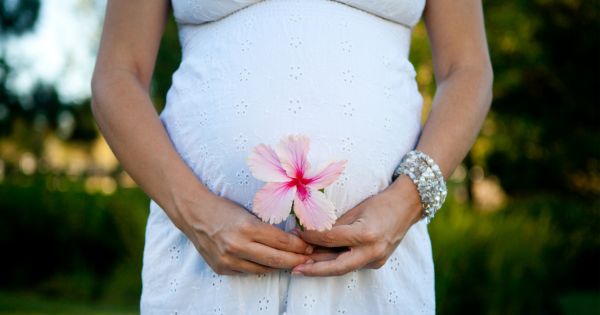 Mom to be holding flower