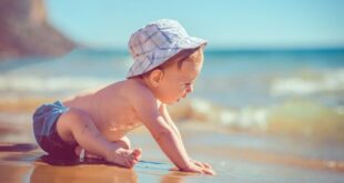 Baby playing at beach