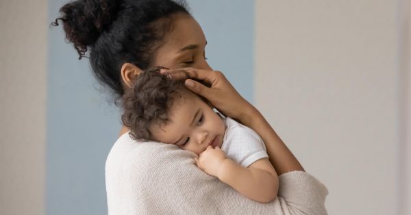 Mom comforting sick baby